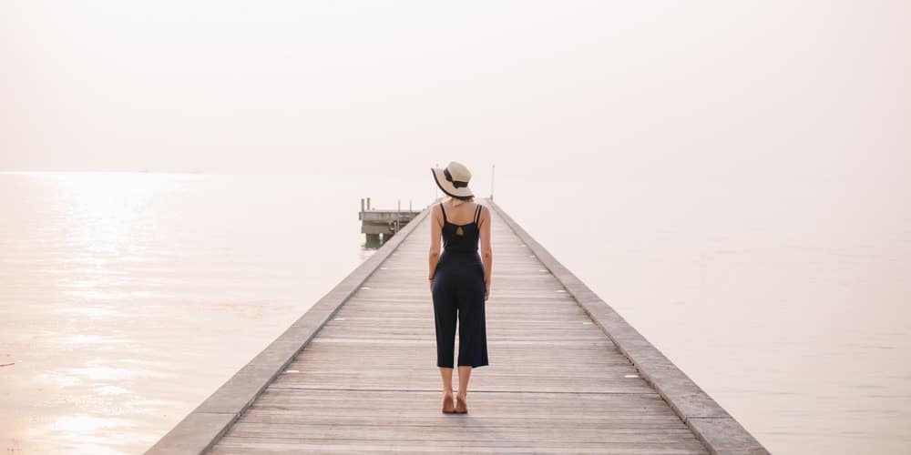 Stylish woman standing on pier