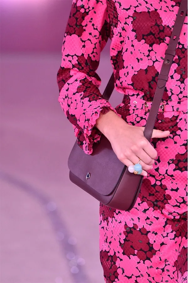 Kate Spade model on runway with bag and floral dress