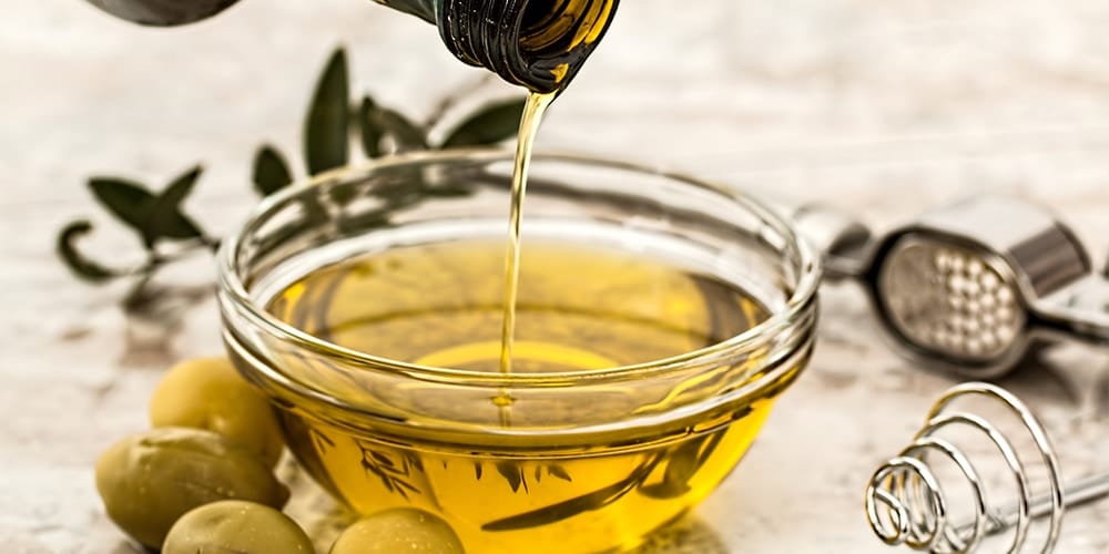 Olive oil being poured into dipping bowl