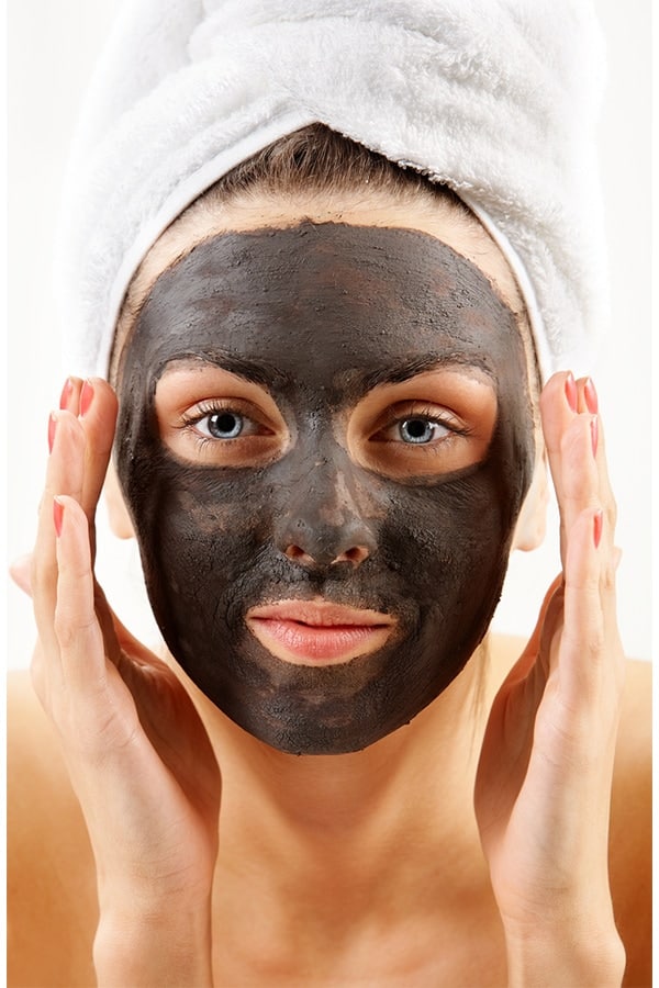 Woman with purifying facial mask