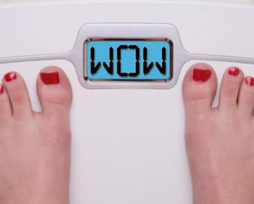 Woman standing on scale, checking her weight