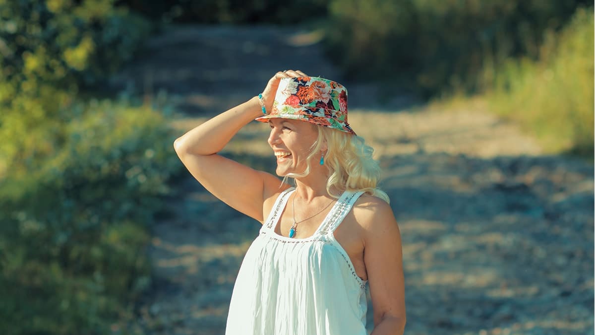 Older woman wearing quirky hat and sundressOlder woman wearing quirky hat and sundress