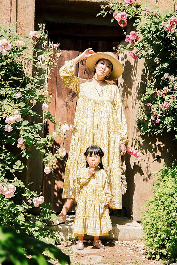 Mommy and Me Fashion: Summer Outfit Picks 1 Mother and daughter wearing matching yellow patterned dresses