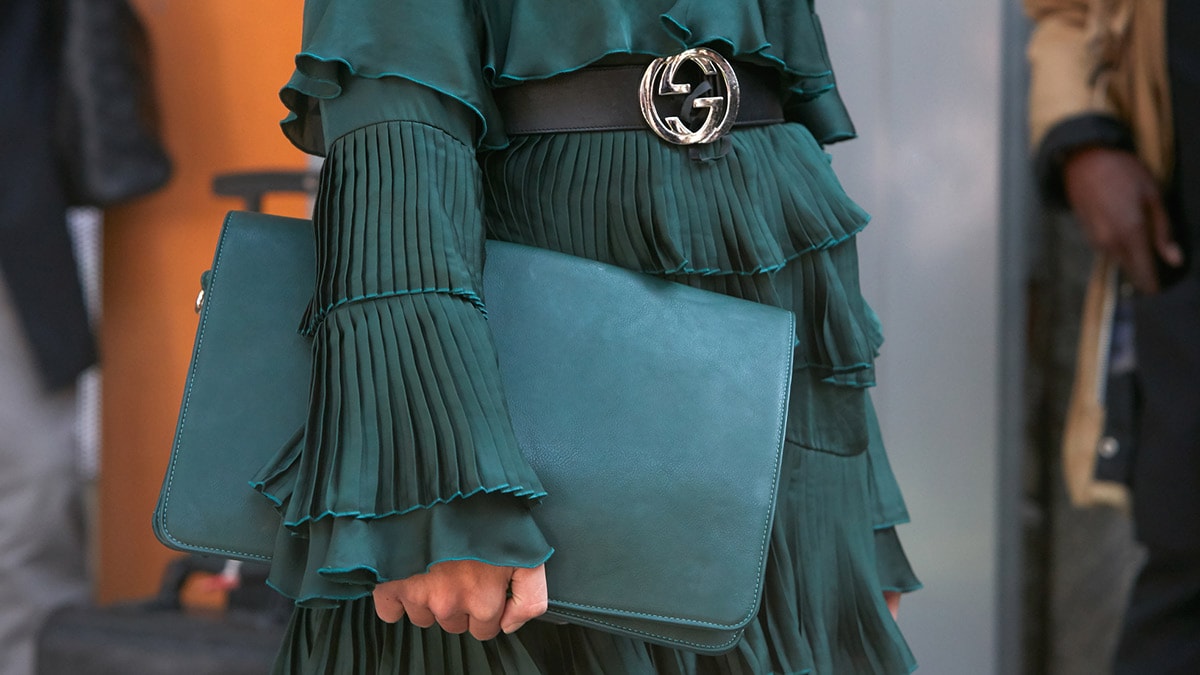 Woman wearing Gucci belt and trending color, forest green