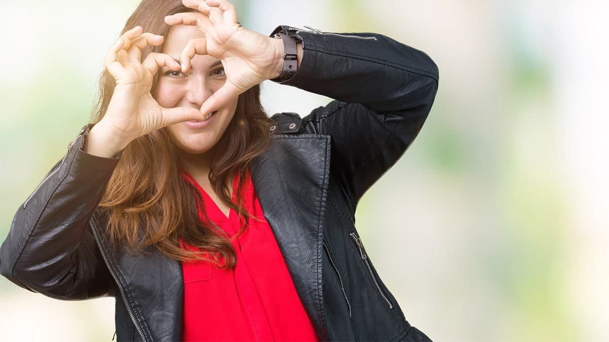 Girl holding up heart hands