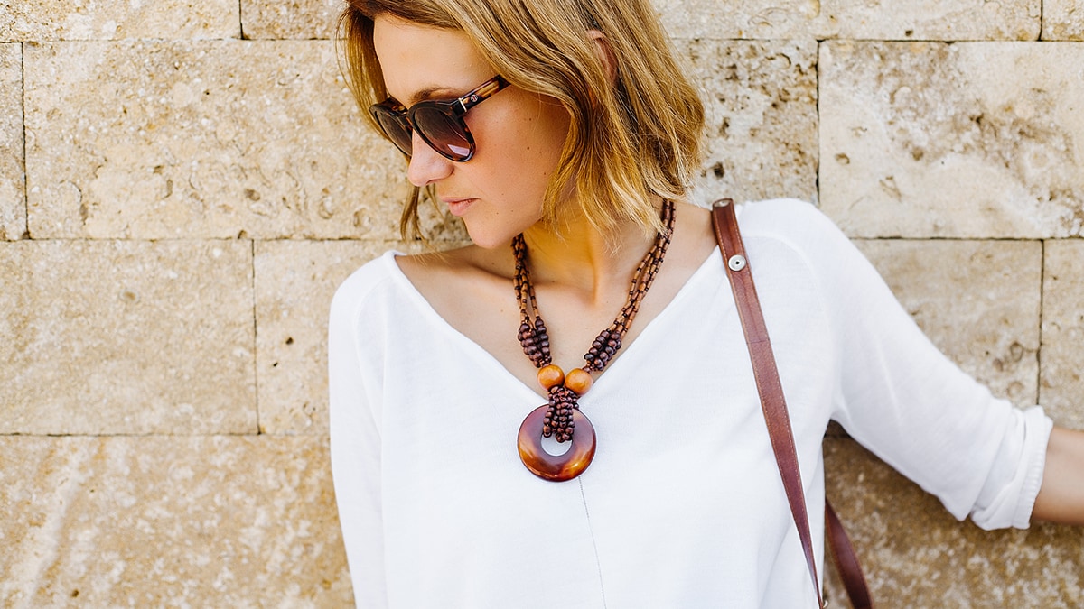 how to dress up casual outfits: woman wearing statement necklace