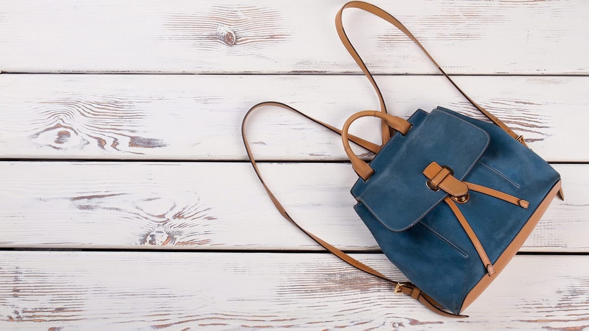 Mini backpack on a wood background