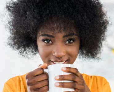 Woman drinking coffee to indulge in cheap treat