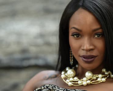 Woman wearing chunky pearl necklace