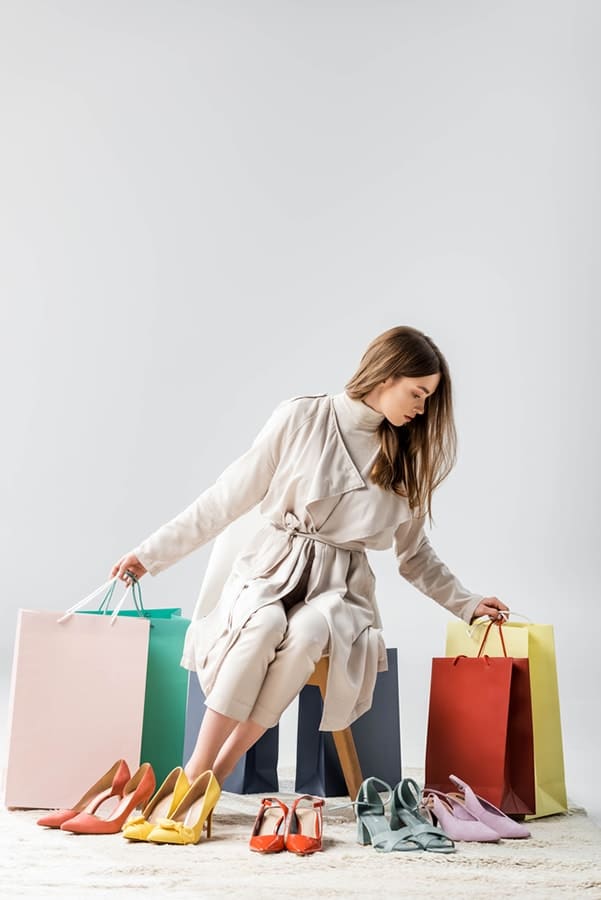 Trendy girl with shopping bags and shoes -- not supporting slow fashion