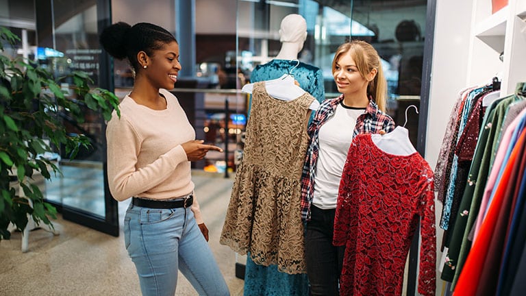 two friends shopping for dresses