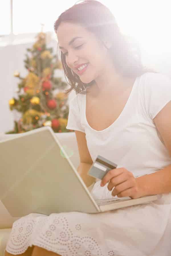 Unwanted Gift Cards? Use Them to Help Yourself or Someone Else 4 Ways 1 Brunette looking up the value of her gift card online.