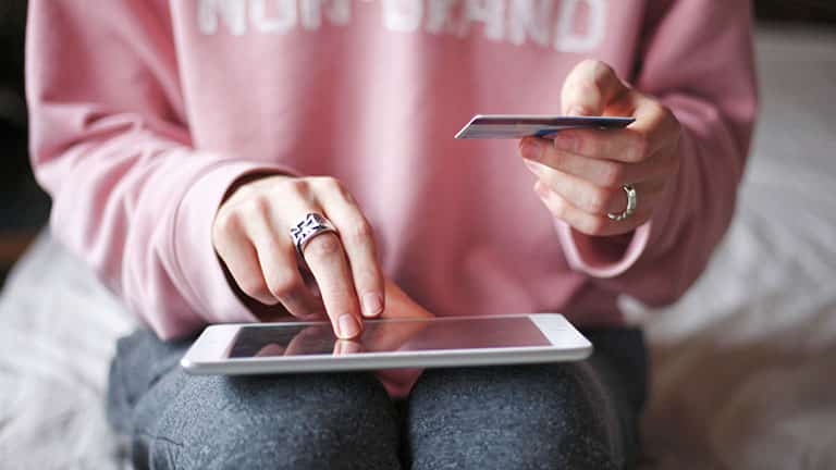 Woman shopping with gift card on National Gift Card Day