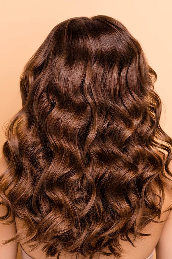 Close up of healthy curled hair from the back of the head.