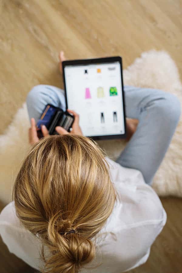 Here's How to Shop Amazon Prime Day and Other Big Sales 2 Woman shopping Amazon Prime Day at home on tablet.