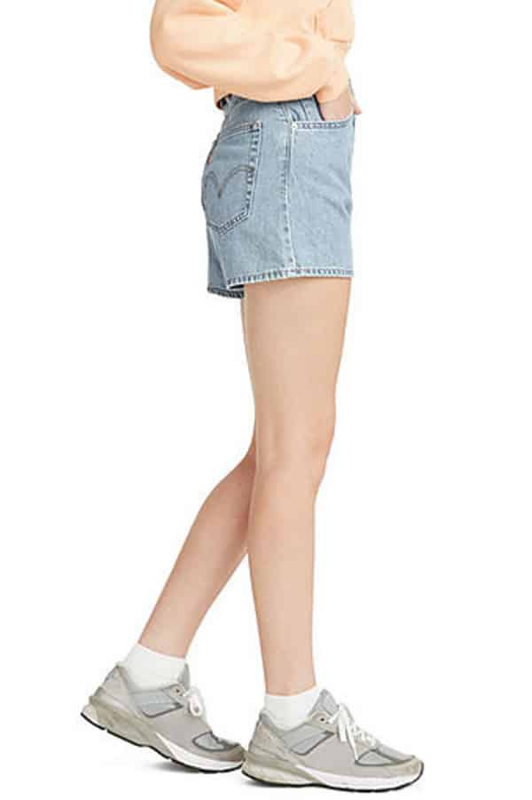 Waist-down view of woman wearing high rise, short shorts.