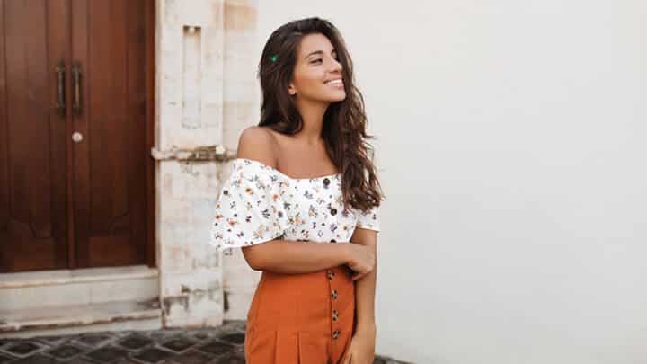 Smiling adult wearing high-waisted shorts.