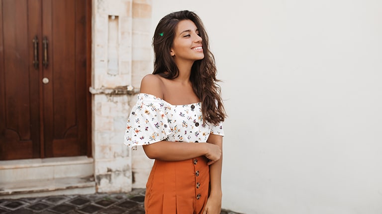 Smiling adult wearing high-waisted shorts.