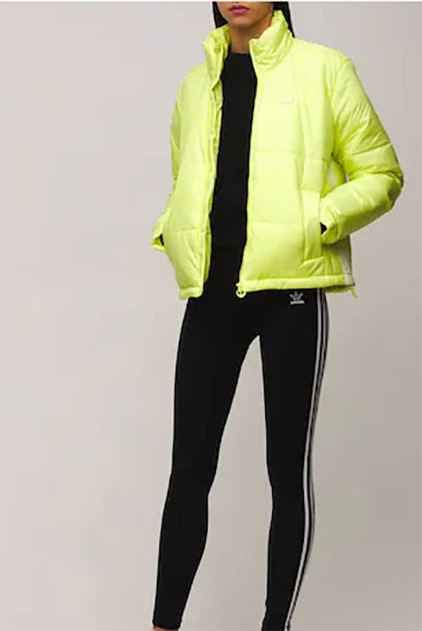 Model wearing neon yellow puffer coat.