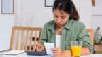 Woman works on household budget because of clothing inflation.