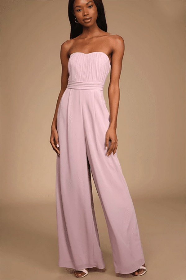 Model wears pale pink jumpsuit.