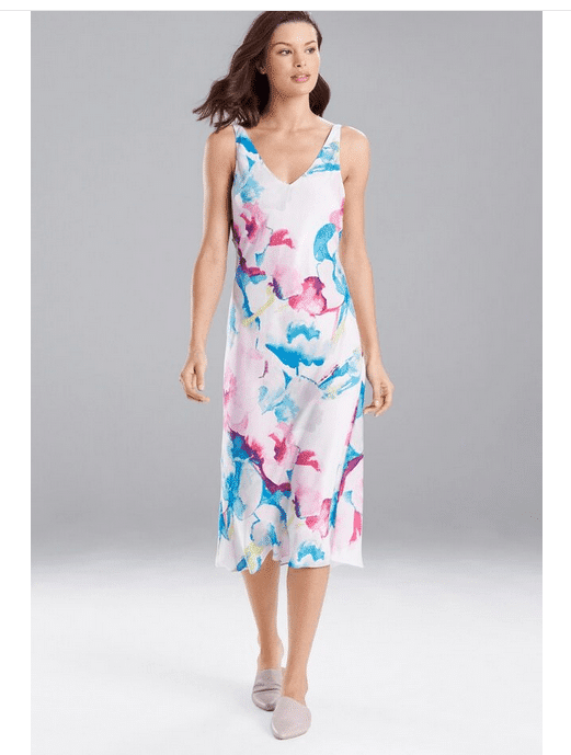 Model wearing white floral dress perfect to wear to a spring wedding.