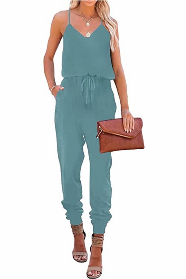 Model wears aqua beach wear jumpsuit.