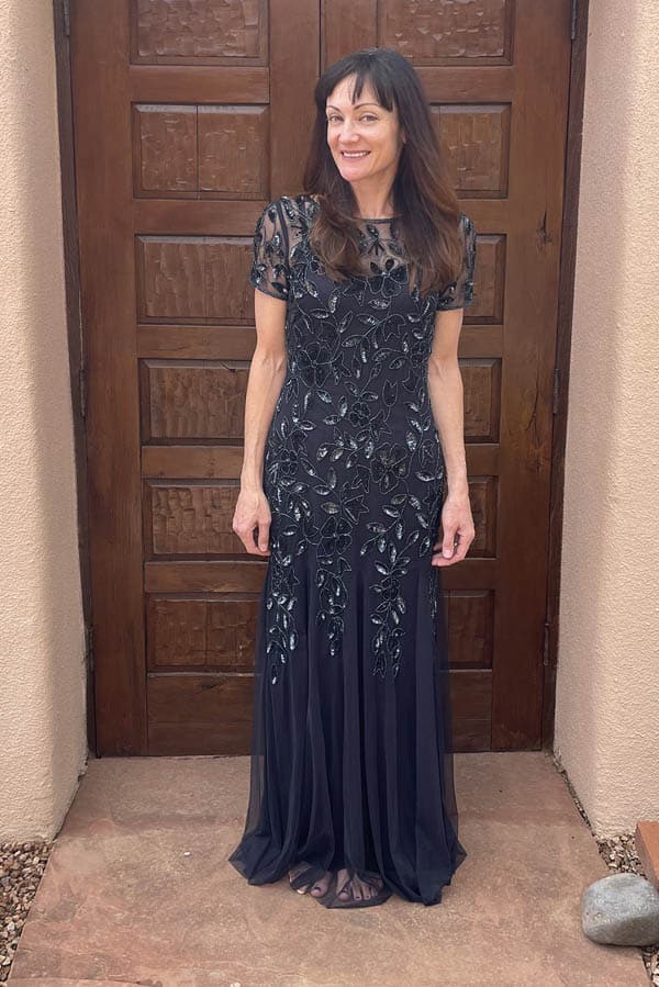 Catherine Brock wearing beaded navy formal gown, available on Amazon.