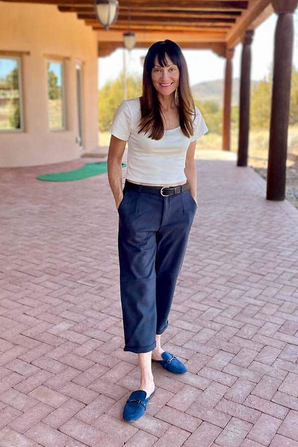 Catherine Brock wearing white crop top and wide-legged crop pants.