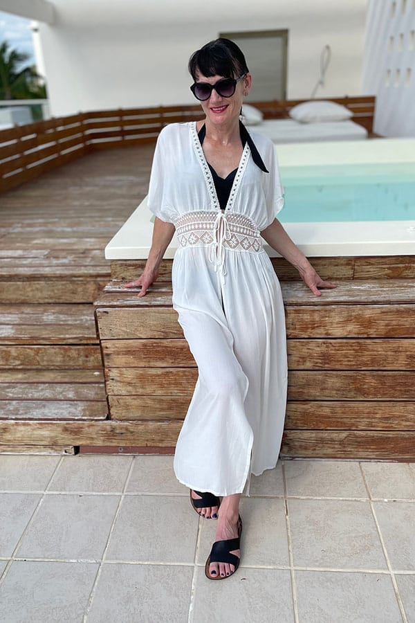 Catherine Brock standing in front of plunge pool on hotel deck, wearing white kimono coverup from Chicwish.