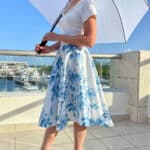 Catherine Brock wearing Chicwish a-line skirt with blue floral pattern and white crop top.
