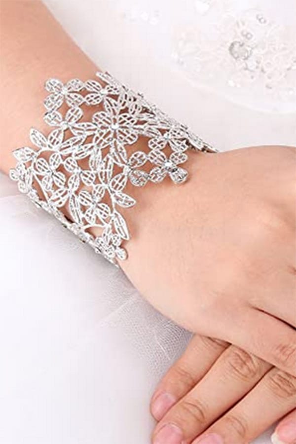 Retro Fashion: 10 Budget-Friendly Accessories + Essential Style Tips 2 Close-up of art deco cuff bracelet on woman's arm.