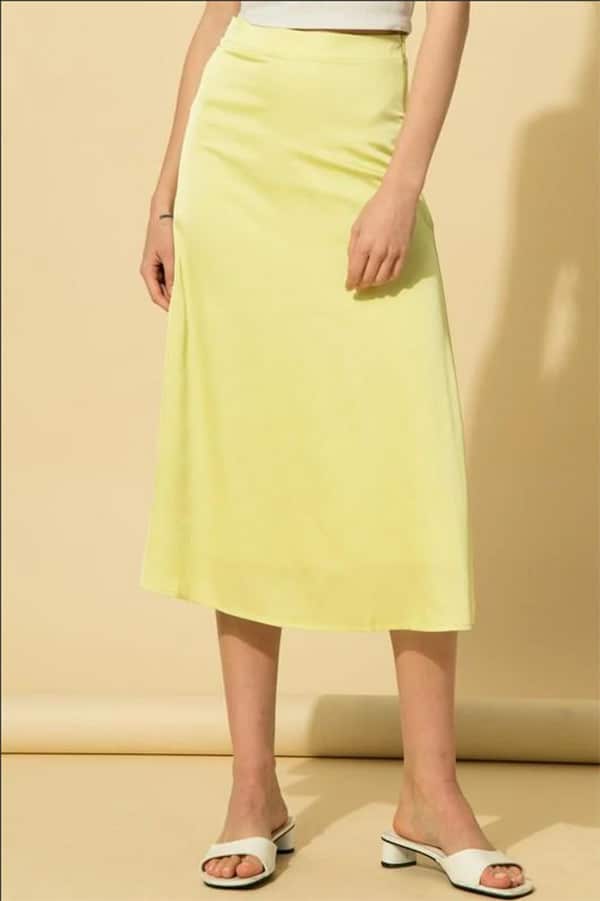 Close up of model wearing neon yellow skirt.