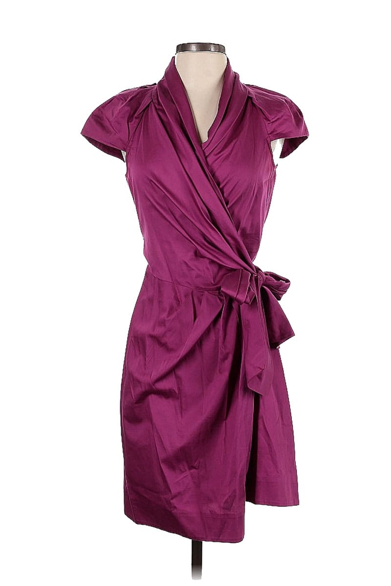 Diane von Furstenberg wrap dress in magenta on white background. 