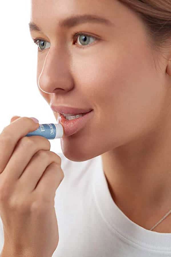 Woman using lip balm sold on Amazon.