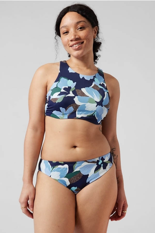 Model wears two-piece patterned swimsuit by Athleta.