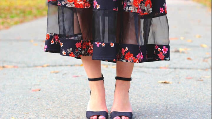 Close up of woman's legs with sheer paneled skirt.
