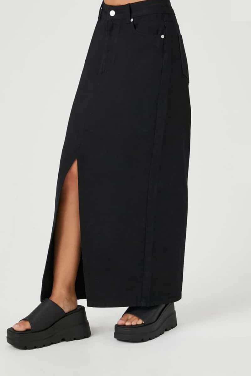 Fall Clothing Checklist: 9 Trendy Pieces You Need 7 Waist-down view of woman wearing denim maxi skirt in black.