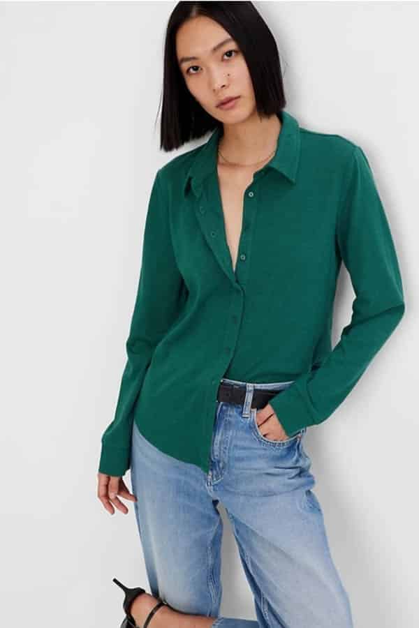 Model wears green button-down top on sale at Gap.