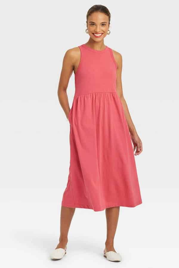 Women wears coral cotton dress.