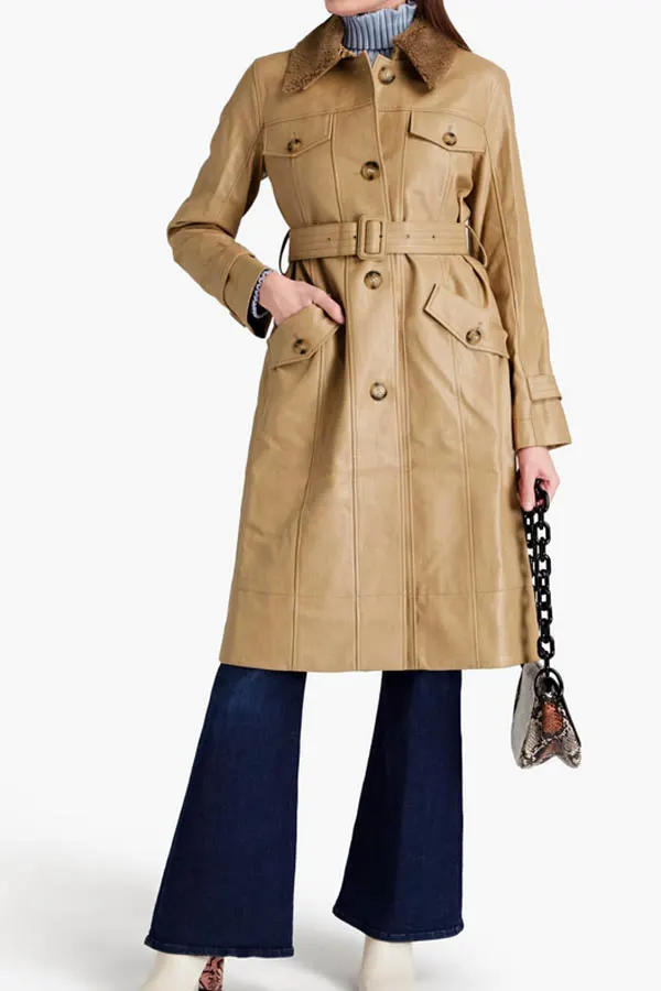 Model wears brown leather trenchcoat.