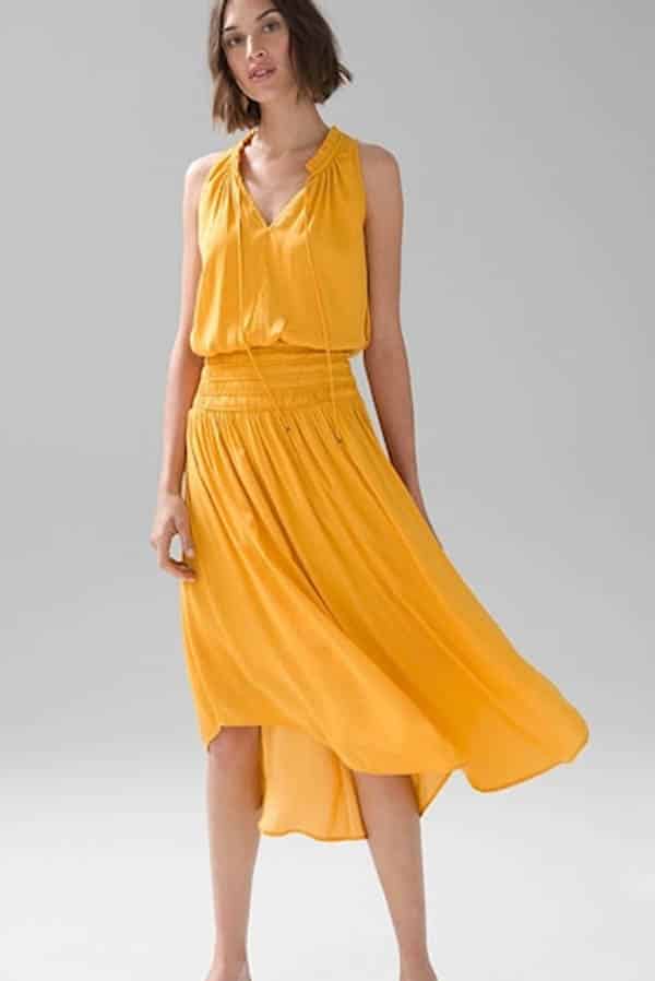 Model wears yellow satin dress on sale at White House Black Market.