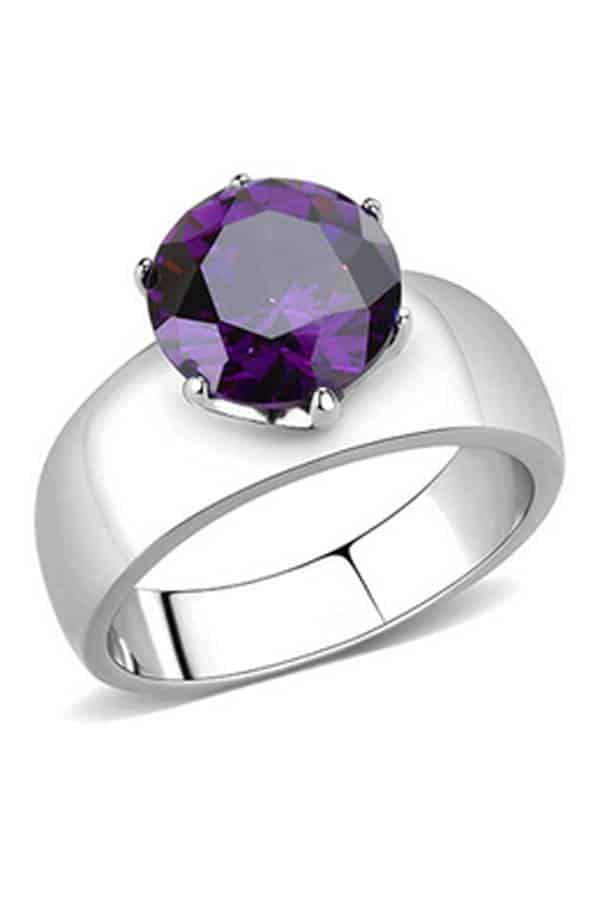 Close up of ring with purple gem set on a silver band.