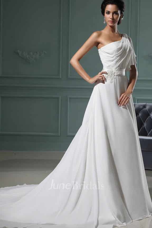 Model wears pleated maxi wedding down with train.