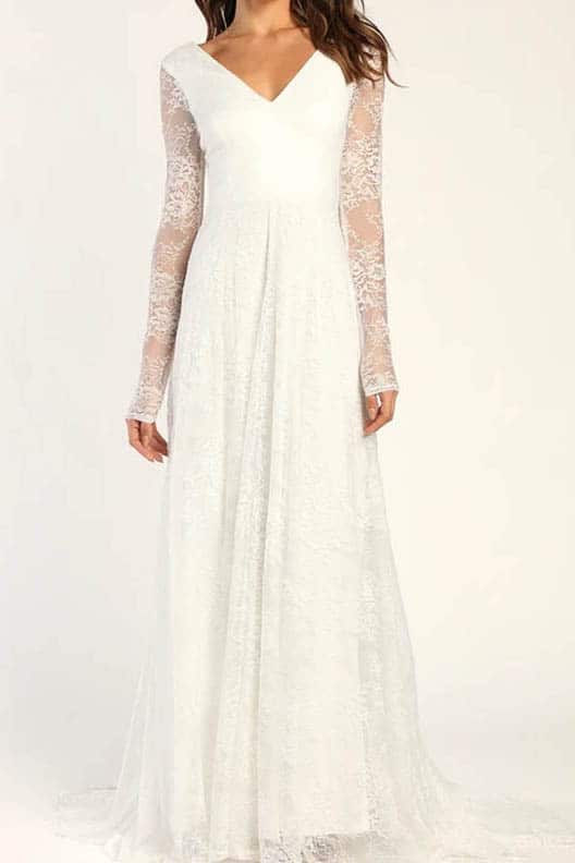 Model wears bridal gown with long sleeves and lace.