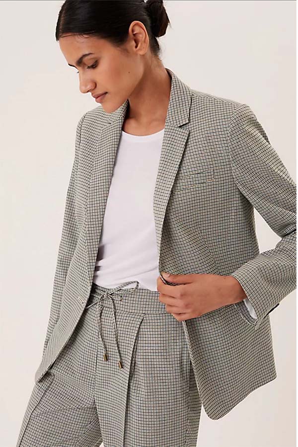 Model wears grey check blazer by Marks and Spencer.