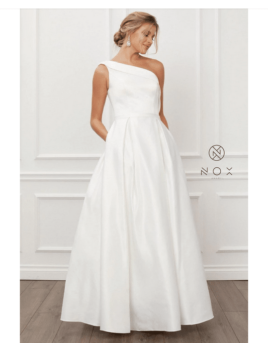 Woman wears white wedding gown with a-line skirt.