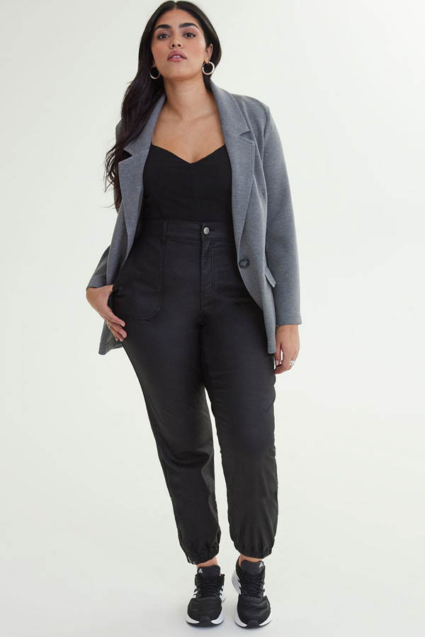 Model wears blazer from plus-size clothing store Addition Elle.