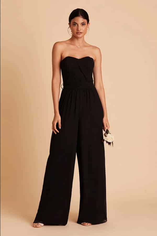 Model wears black strapless jumpsuit.