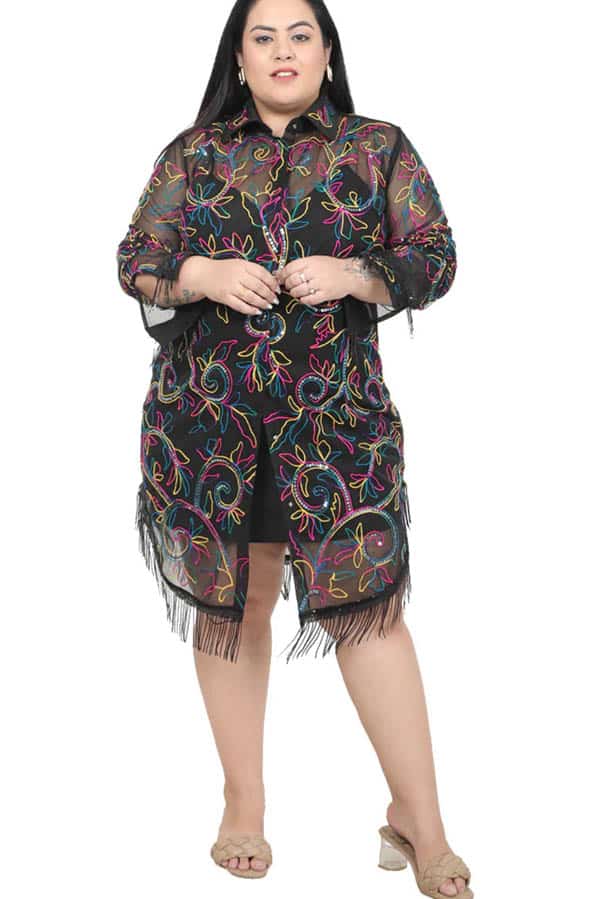 Model wears fringe black dress from plus-size clothing store Curve Girl.